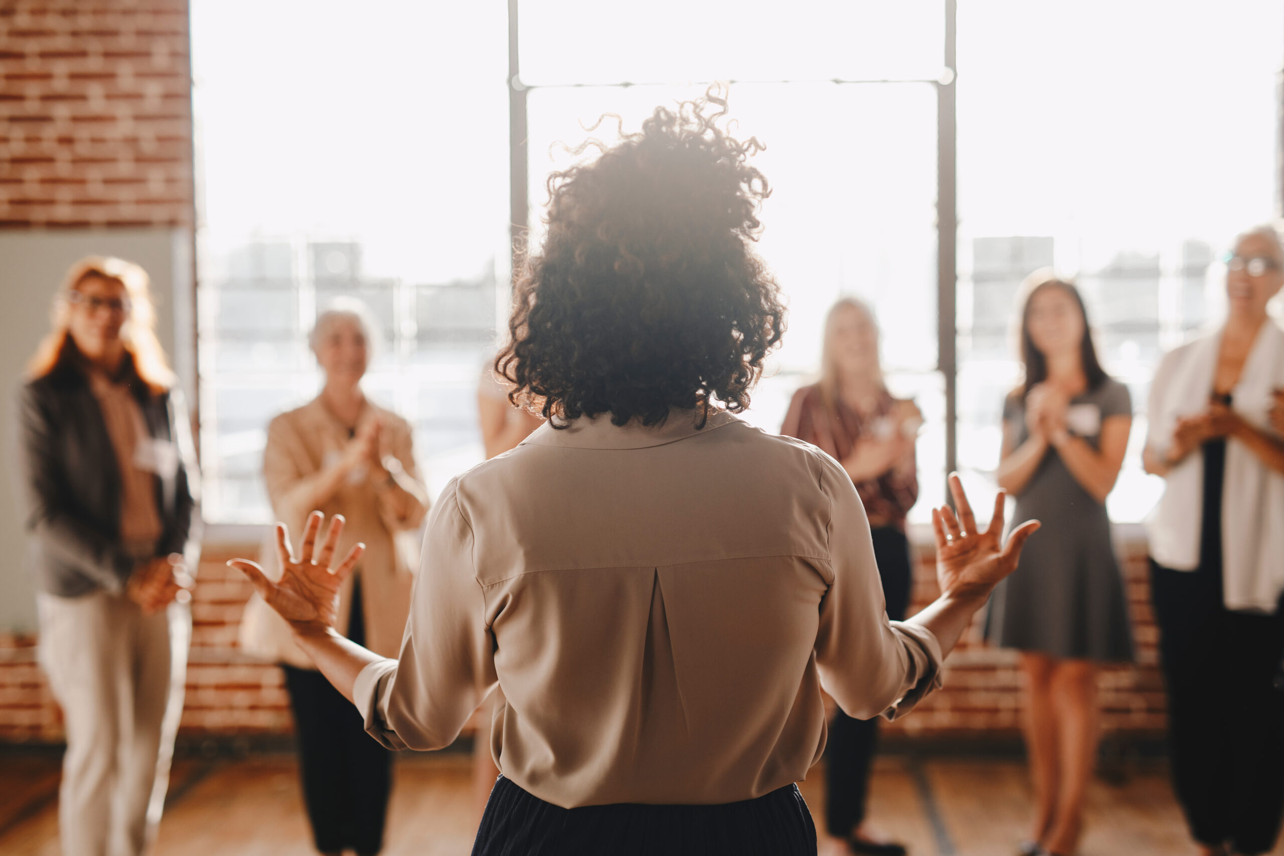 A professional woman leading a team meeting with confidence