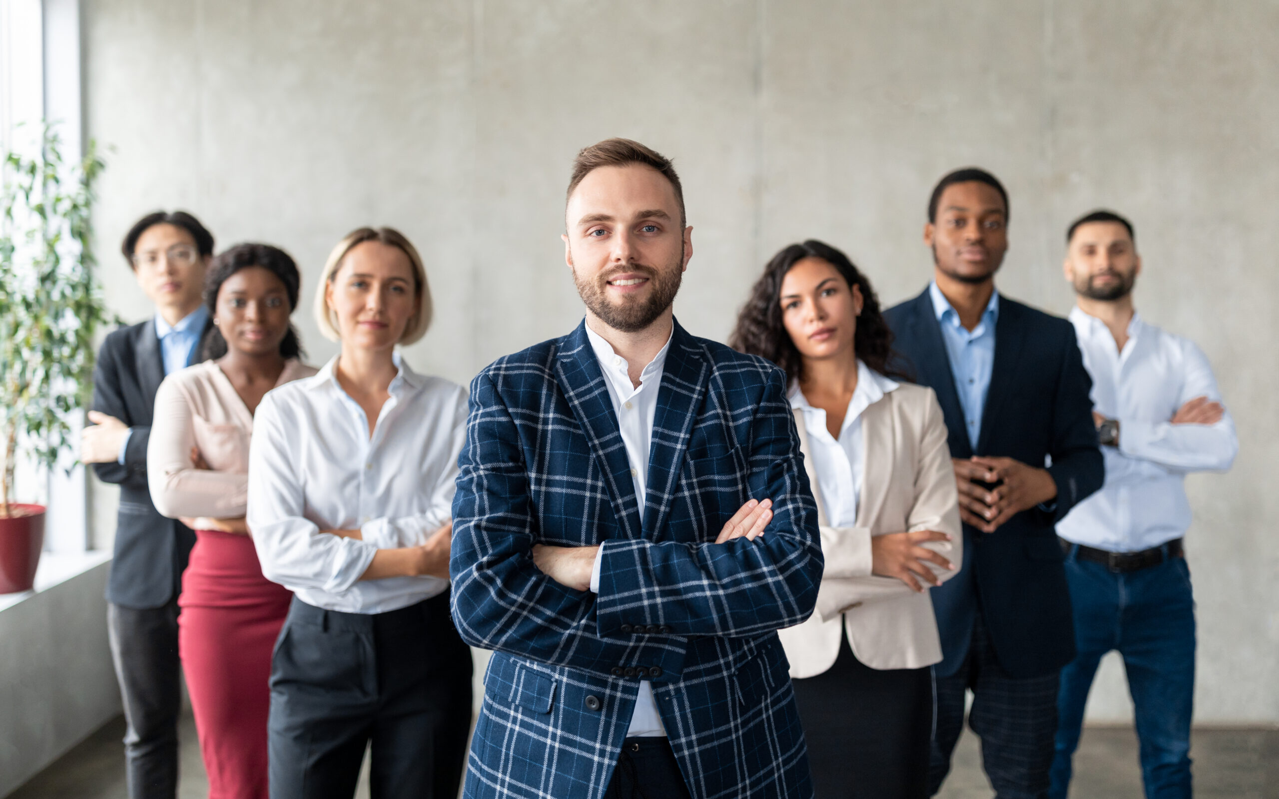 A group of business professionals standing together and looking confident.
