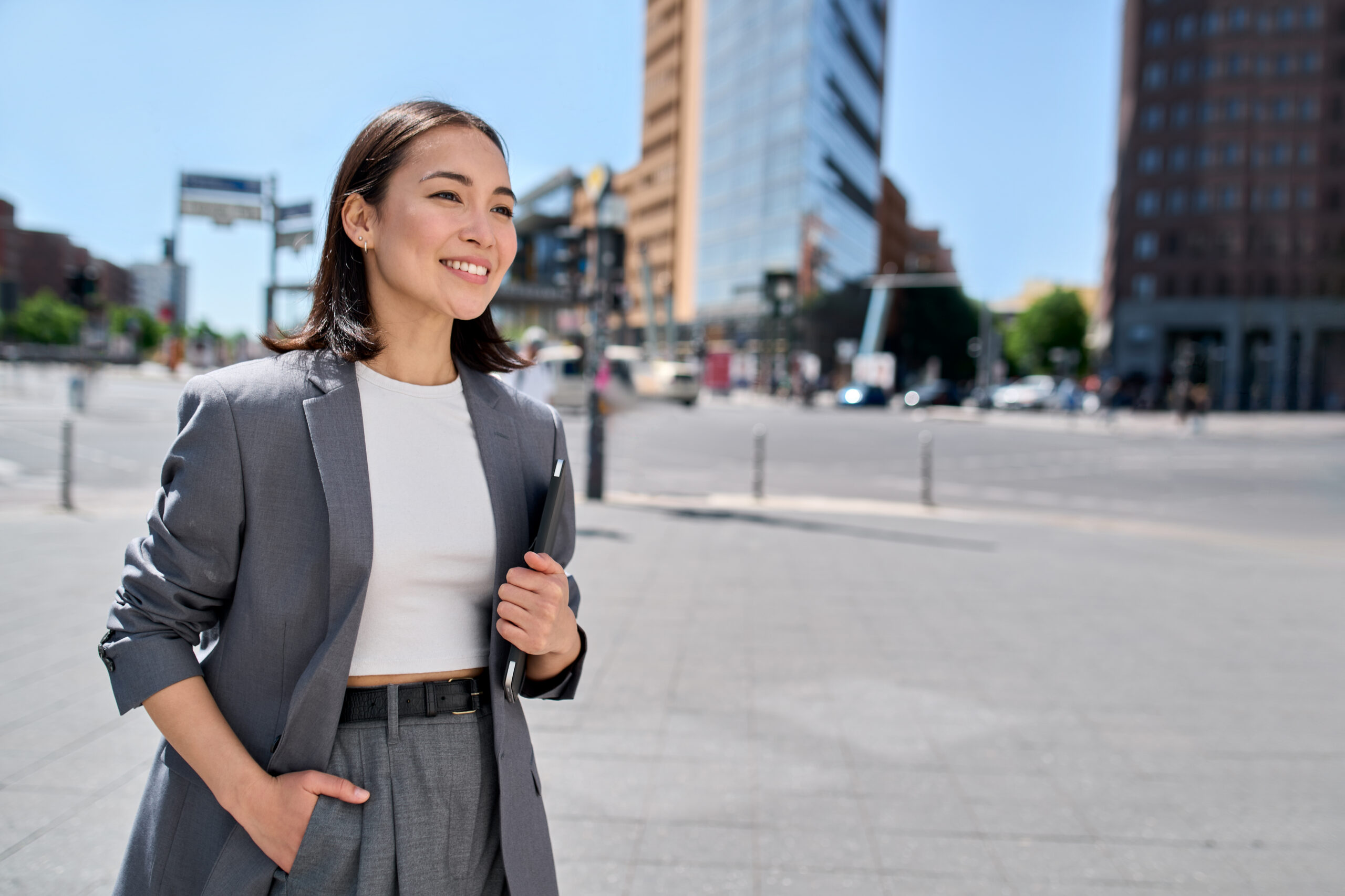 A young business professional walking confidently through an urban environment